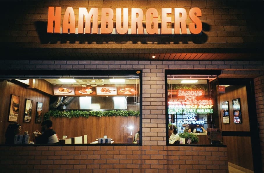 The Onestar Old-Fashioned Hamburgers storefront lit up at night